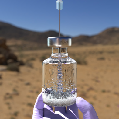 Purple-gloved hand holding a vial in the desert
